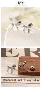 Detailed view of silver bow-shaped stud earrings with secure spiral screw backs