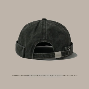 Detail of adjustable silver metal buckle on washed cotton distressed docker cap