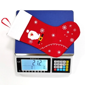 Christmas stocking with Santa Claus and snowflake embroidery hanging on a digital scale