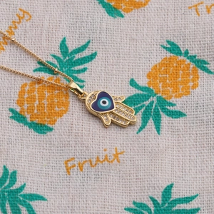 Gold plated Hamsa hand necklace with blue heart evil eye and sparkling zircon stones