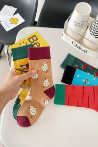 Close-up of colorful cotton socks with animal and fruit patterns like chicken and strawberry