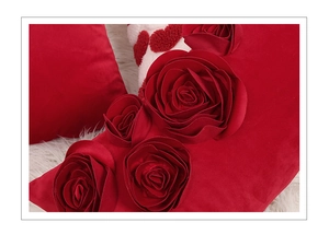 Detailed macro view of velvet cushion cover with 3D red rose floral petals texture
