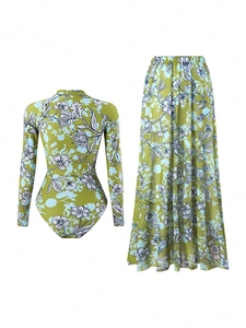 Flat lay of olive green long sleeve bikini and floral print beach skirt two-piece set
