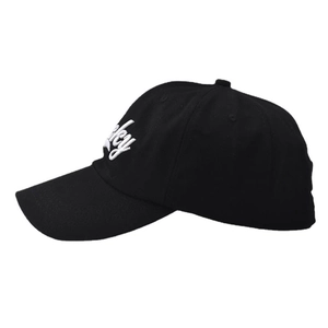 Détail de la broderie Lucky blanche sur une casquette de baseball en coton noir à visière