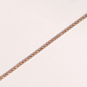 Detail of silver tennis bracelet featuring prong-set yellow round cubic zirconia stones