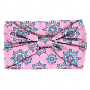 Macro detail of pink mandala floral patterned headband with a central bow knot design