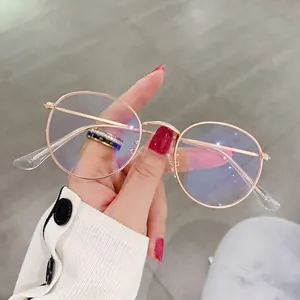 Classic oval rose gold metal frame glasses with blue light blocking lenses in hand