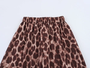 Close-up of elastic waistband on classic leopard print trousers with soft fabric texture