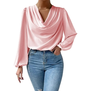 Close-up of pink satin blouse featuring elegant draped neckline and lantern sleeves