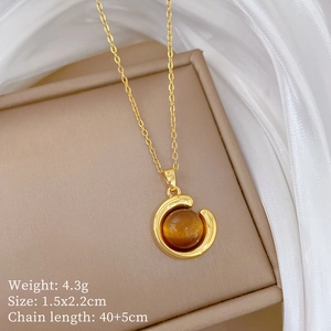 Close-up of golden necklace with amber gemstone pendant on silk background, weight 4.3g