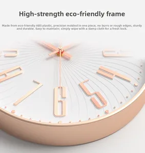 Detail of rose gold frame and white textured dial with embossed numerals on 12 inch wall clock