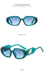Detail of lake blue oval sunglasses with gold leaf accent and grey blue lenses