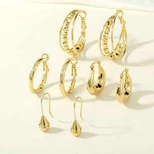 Detailed close-up of a high-quality textured gold earring set with four distinct designs