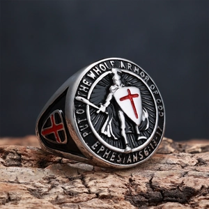 Detail of knight shield ring with red cross and Bible quote on natural bark