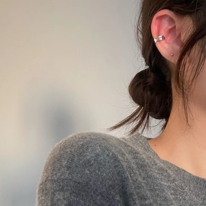 Minimalist S925 sterling silver ear cuff with irregular design worn by a female model