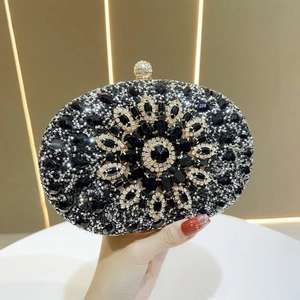 Detailed close-up of a silver floral rhinestone evening clutch with a crystal push-lock