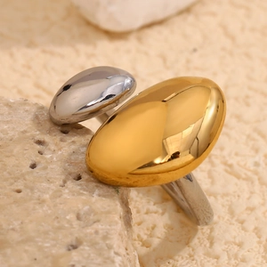Macro view of bicolor 18K gold and silver stainless steel ring on a natural stone surface