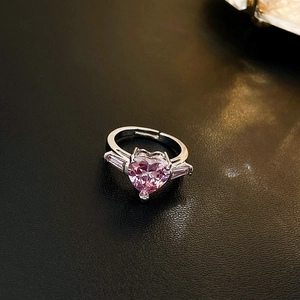 Close-up of pink heart zircon ring with baguette side stones on black leather