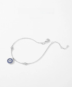 Macro shot of s925 silver evil eye bracelet with blue zircons and lobster clasp closure