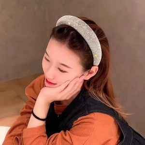 Close-up of sparkling silver rhinestone headband worn by a model for a high-end look