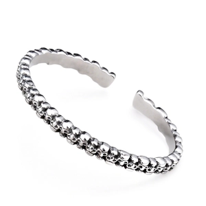Retro punk skull relief open bangle in silver stainless steel, 45-degree angle view