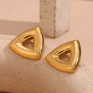 Macro shot of 18K gold plated hollow triangle stud earrings on stone base