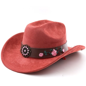 Detail of red faux suede western hat featuring floral embroidery on a brown leather band