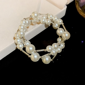 Detail of multi-layer pearl bracelet with silver tubes in a white jewelry gift box
