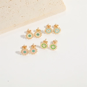 Set of 4 pairs of gold gear-shaped evil eye stud earrings with colorful enamel accents
