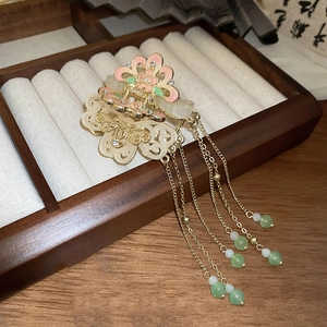 Detail of Chinese style hair clip with pink enamel flowers and long tassels