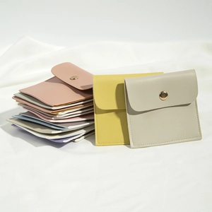 Detailed view of colorful PU leather jewelry pouches with golden snap button closures