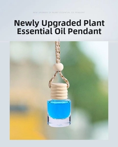 Close-up of glass car perfume bottle with blue essential oil and wooden cork cap