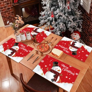 Set of 4 red Christmas snowman placemats with Merry Christmas text on a wooden table