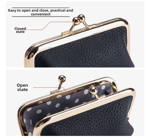 Detail of black pebbled leather coin purse showing gold clasp closure and polka dot lining