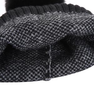 Detail of the thick knit texture and soft faux fur pom-pom on this winter beanie