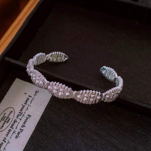 Detailed view of silver open cuff bracelet with vintage textured industrial style links
