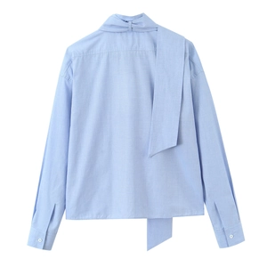Light blue long-sleeved shirt with decorative bow collar and cotton linen texture, back view