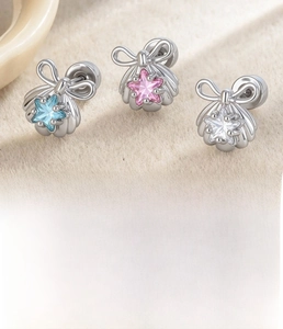 Macro detail of star-shaped cartilage stud with blue zircon and stainless steel disc back