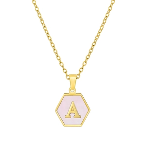 Macro view of gold hexagon pendant with pink shell inlay and letter A detail