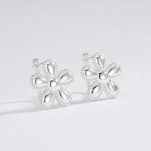 Detail of S925 sterling silver flower earrings with polished beaded petal edges