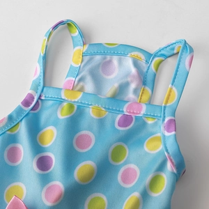 Detail of breathable knit fabric with colorful polka dots on a blue pet dress strap