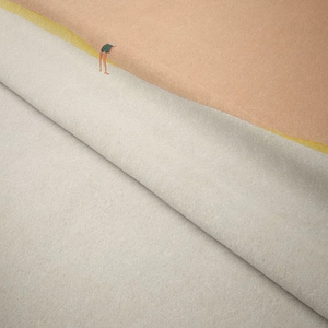 Close-up of bohemian tapestry fabric texture with miniature figure embroidery detail