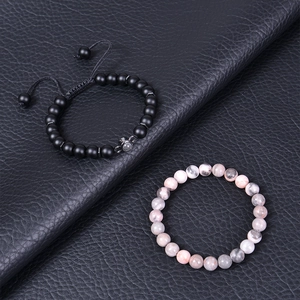 Close-up of matte black stones and marble texture beads on high-quality leather