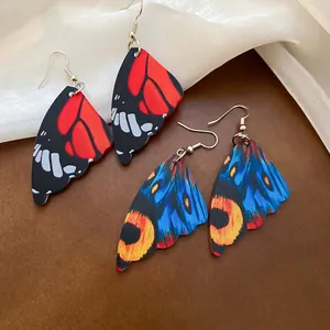 Exaggerated butterfly wing acrylic earrings with intricate nature patterns and silver hooks