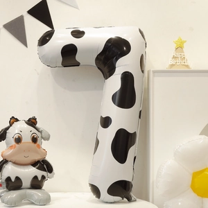 Detail of a 40-inch number 7 foil balloon with black and white cow print for parties