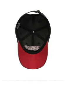 Close-up of black cotton baseball cap interior with red brim and adjustable strap