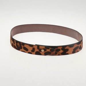 Close-up of leopard print leather belt with snap button and animal pattern detail