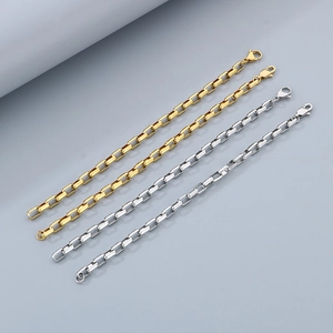 Detail of gold and silver box chain bracelets with lobster clasps in polished stainless steel