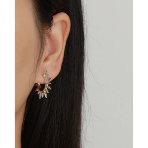 Detailed view of silver S925 sunburst hoop earrings with minimalist spiked sun design