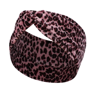 Detail of pink leopard print velvet headband with twist knot texture and soft finish